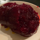 A thoroughly unappealing image of jarred cranberry sauce on a plate.